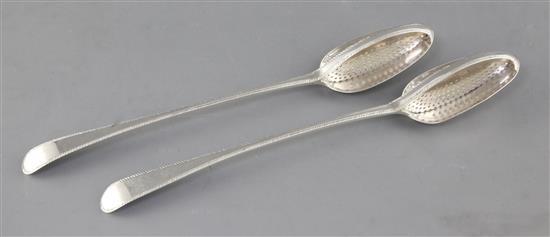 A pair of George III silver feather edge Old English pattern straining spoons, 6.5 oz.